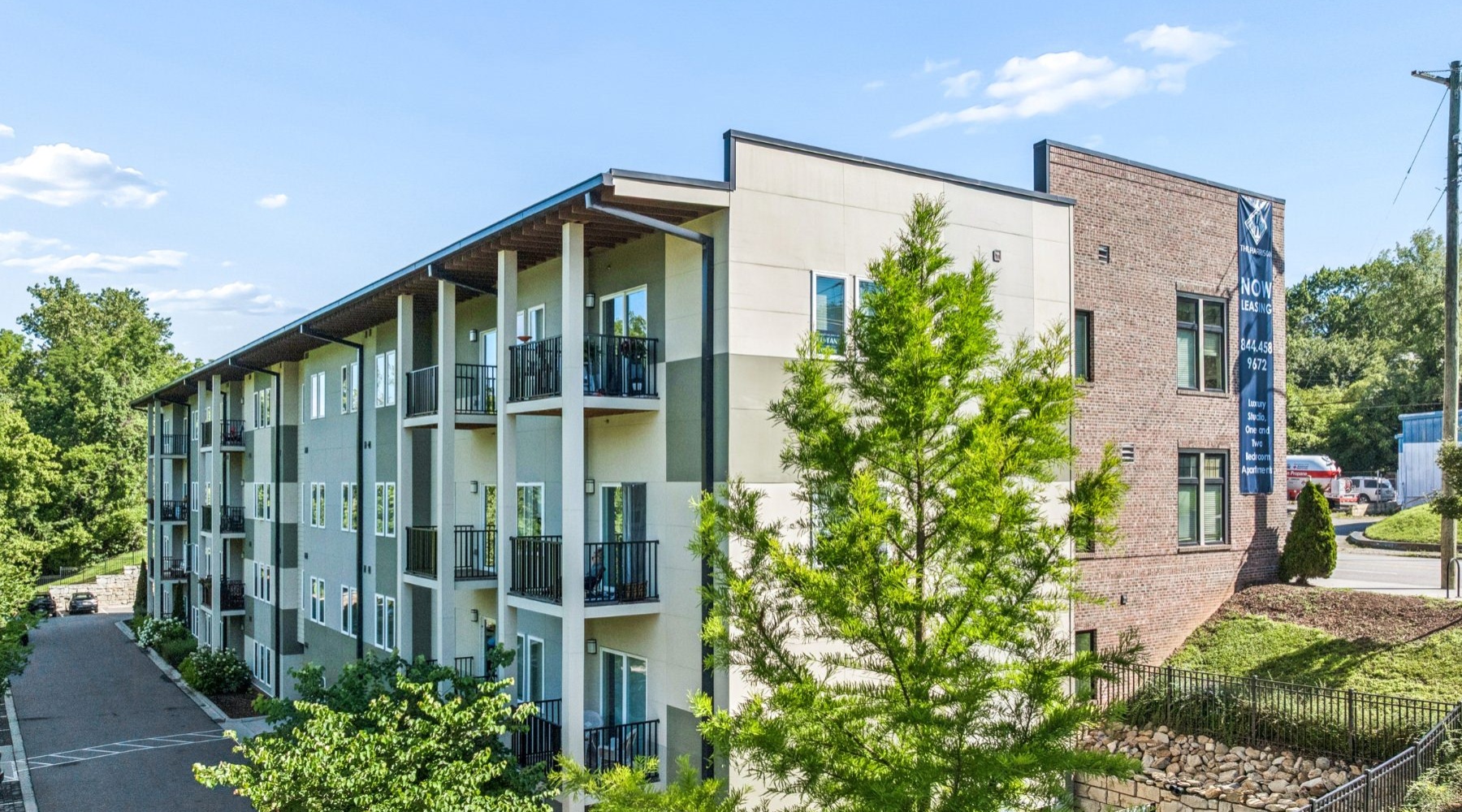 a building with multiple levels and a trees