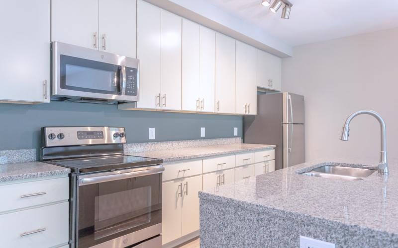 a kitchen with white cabinets